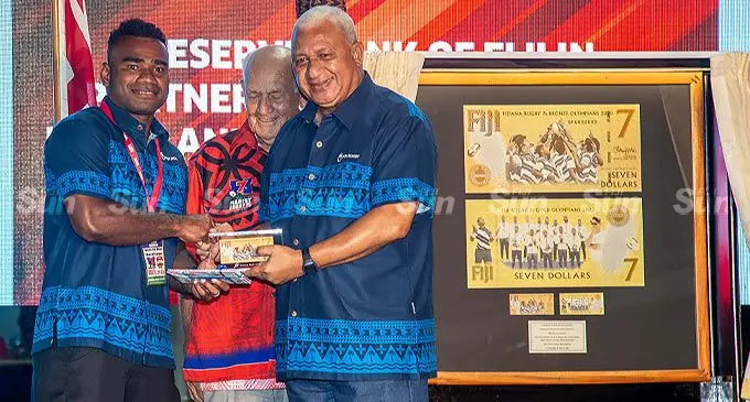 From left: 7s star and captain Jerry Tuwai, Marist Rugby Club patron Brother Sam Eathorne and Prime Minister for Voreqe Bainimarama during the unveiling of the commemorative circulation $7 banknote at the 2022 Fiji Bitter Marist 7s on March 26, 2022. Photo: Leon Lord
