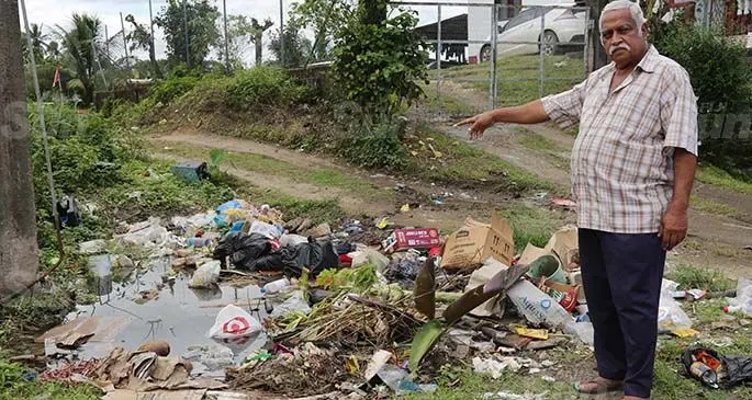 Vijay Singh of Kelland Street, Narere, points at the pile of rubbish on their street roundadbout on July 4, 2020. Photo: Kelera Sovasiga