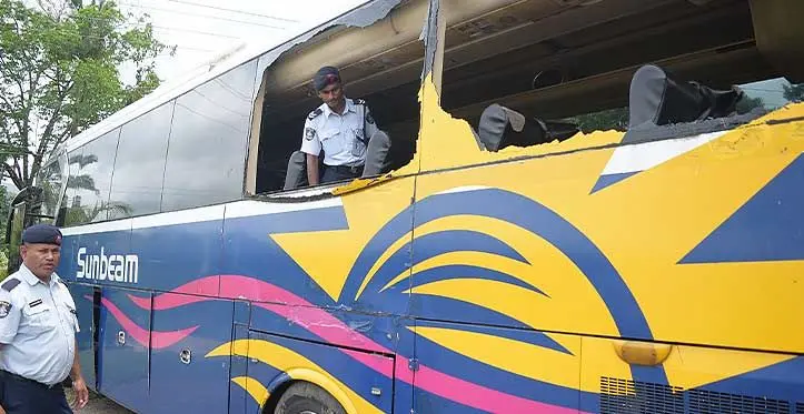 Wainadoi Community Police Post Corporal Alfaaz Khan (right) and Constable Ilimo Vudiniabola investigate the damaged bus on November 7, 2023. Photo: Ronald Kumar