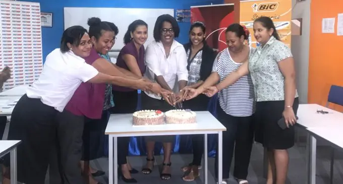 Post Fiji and Vodafone Fiji women cut the cake to celebrate International Women's Day together during the Post Fiji back to school promotion draw yesterday in Suva. Photo: Selita Bolanavanua