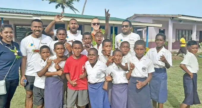 Kerry Kalendra, Founder & CEO of MTA Mor tgage Brokers with Volunteers and students of Malomalo Primary School. Photo: Intercontinental Fiji Golf Resort & Spa