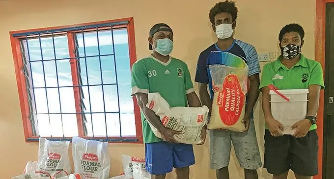 Fiji Football Association Development officer North Sailasa Bera, Labasa midfielder Siotame Kubu and Labasa Women’s Football captain Jotivini Tabua during the handing over of food packs on June 17, 2021. Photo: Laisa Lui
