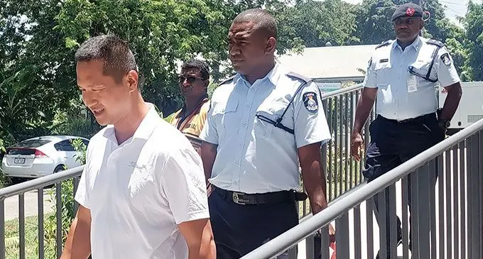 Grace Road Fiji president Daniel Kim is escorted to the Tagimoucia Court Complex in Lautoka on December 13, 2023. Photo: Salote Qalubau