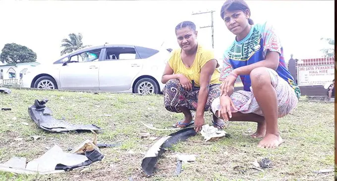 Bulou Litia Suluaqalo (left) and Marama Gaga hold broken parts of the two vehicles that collided at Nasole junction on September 12, 2020. Photo: Inoke Rabonu
