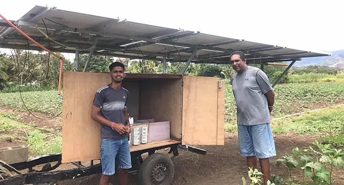 From left: Resolution Technologies owner Kaushik Kumar and his father Atish Kumar infront of the solar panels and inverter which powers the irrigation system at their farm in Buabua, Lautoka. Photo: Shreya Kumar.