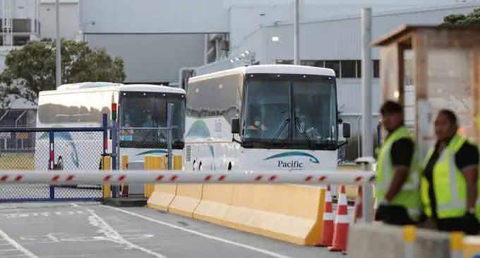 Buses leave Auckland Airport with evacuees from Wuhan. Photo: NZH