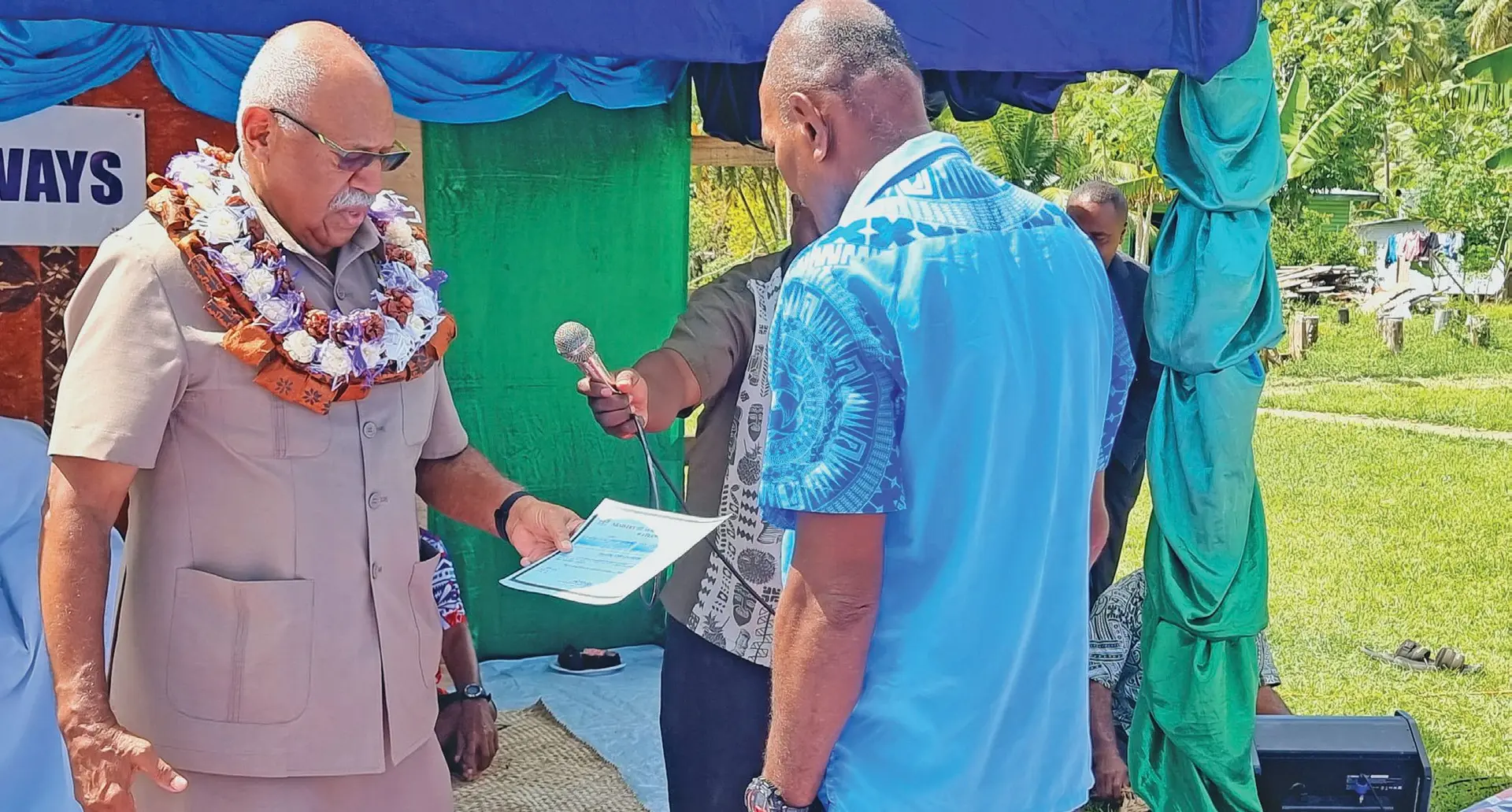 Prime Minister, Sitiveni Rabuka, hands over the certificate of completion of the  Naividamu seawall to village headman and Macuata District rep, Semi Qamese. Photo: Sampras Anand.