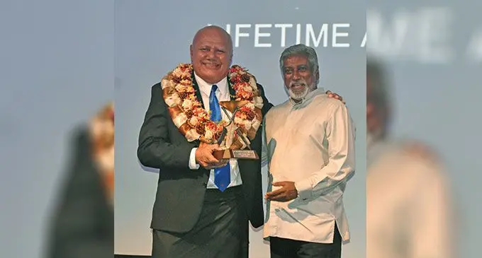 Deputy Prime Minister and Minister for Tourism and Civil Aviation Viliame Gavoka hands over the lifetime award to Tour Managers managing director Damend Goundar on February 25, 2023. Photo: Waisea Nasokia