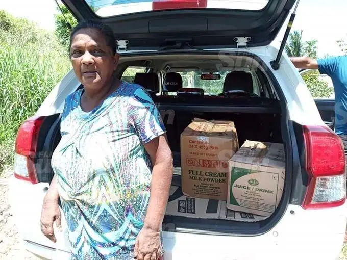 Vishnu Baru receiving her boxes of groceries from Ishaad Khan and his circle of friends team on October 23, 2020.