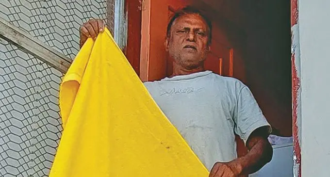Anil Singh stands at the door where the two robbers entered and shows the towel that was used to wrap his face.  Photo: Nicolette Chambers 