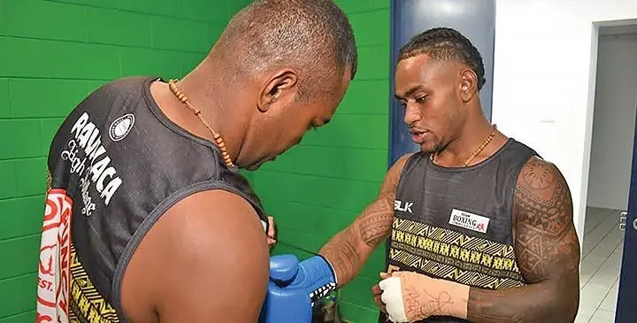 Fiji super featherweight champion Mikaele Ravalaca (right) with his trainer Nester Ranuku. Photo: Supplied