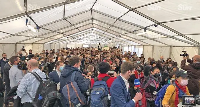 On the final day of the COP26 summit, climate campaigners walk through the blue zone to join protestors outside the Scottish Exhibition Centre in Glasgow, Scotland.. Photo: Rosi Doviverata