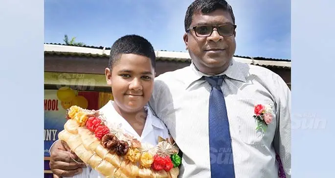 Swami Shraddhanand Memorial School (SSM) head boy Vishnava Reddy and father Minister for Agriculture, Environment and Waterways Mahendra Reddy after the prefects induction at the school on February 24, 2021. Photo: Ronald Kumar
