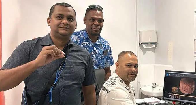 Patient (first from left) with Clinical Director Dr Sanson Fousaga (sitting) and PSH Research and Development Team Head Solomone Suguta.
