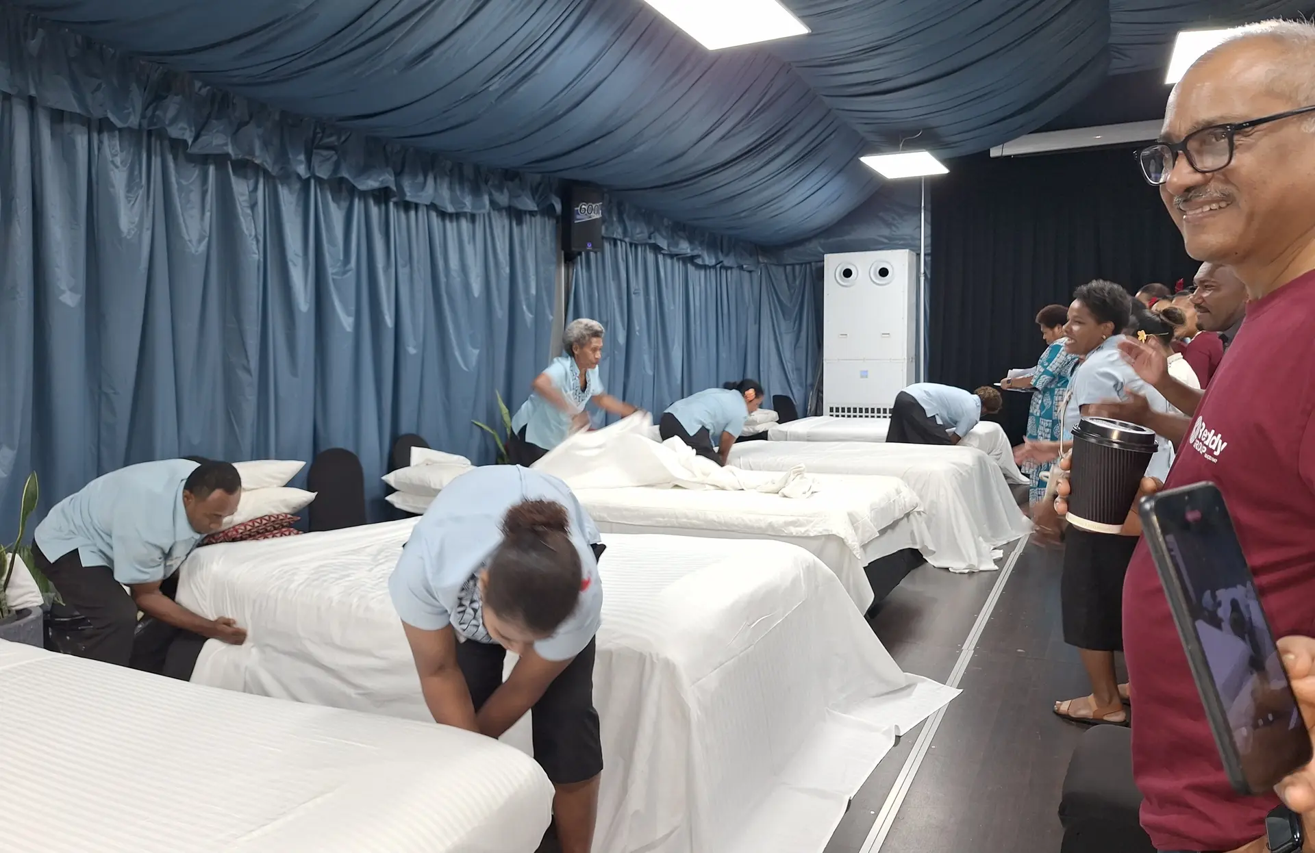Tanoa Group of Hotels area general manager Narend Kumar (nearest to camera far right) watches competitors compete in the bed-making competition. Photo: Waisea Nasokia 