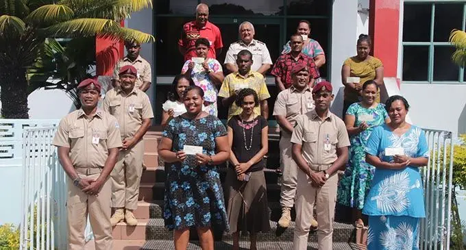 Fiji Corrections Service commissioner Commander Francis Kean (back row, centre) after the Corrections Service donated $300 each to 10 families of Corrections  officers whose work were affected by the COVID-19 pandemic.