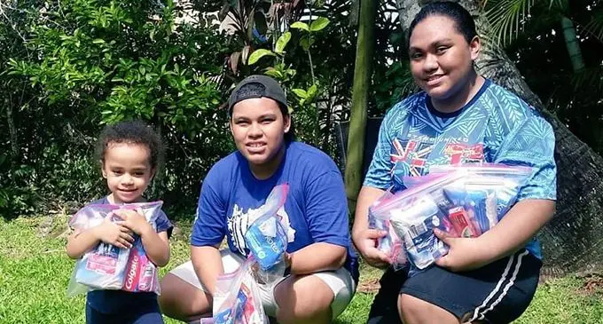 AnneMary Raduva (right) with her siblings holding the dignitary packs. 