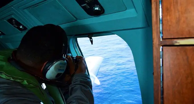 Aerial surveillance with a Fiji Navy official.