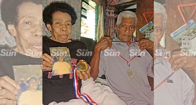 Proud parents from left: Bulou Joma (mother) and Joji Seqa (father)of Nauluvatu settlement in Suva, holding medals won by their daughter Joma Rubuti who plays prop for the Fijiana Drua. Photo: Laiseana Nasiga