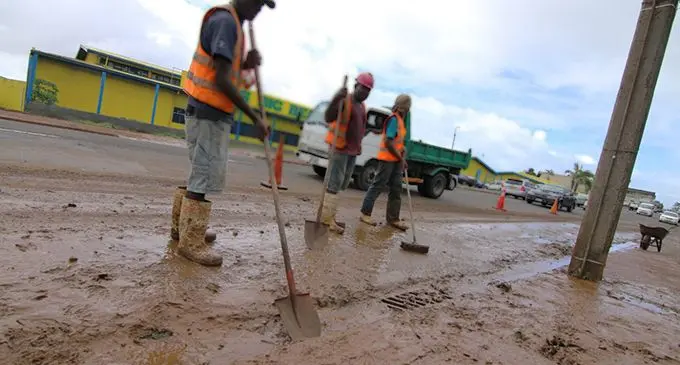 Council workers clean up mud. PHOTO: FILE