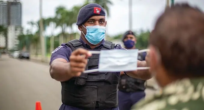 Police Constable Suliasi Lagi reminds a member of the public on June 3, 2021, that wearing a face mask to prevent the spread of COVID-19 is now mandatory, and not wearing one will carry a spot fine.  File Photo: Leon Lord