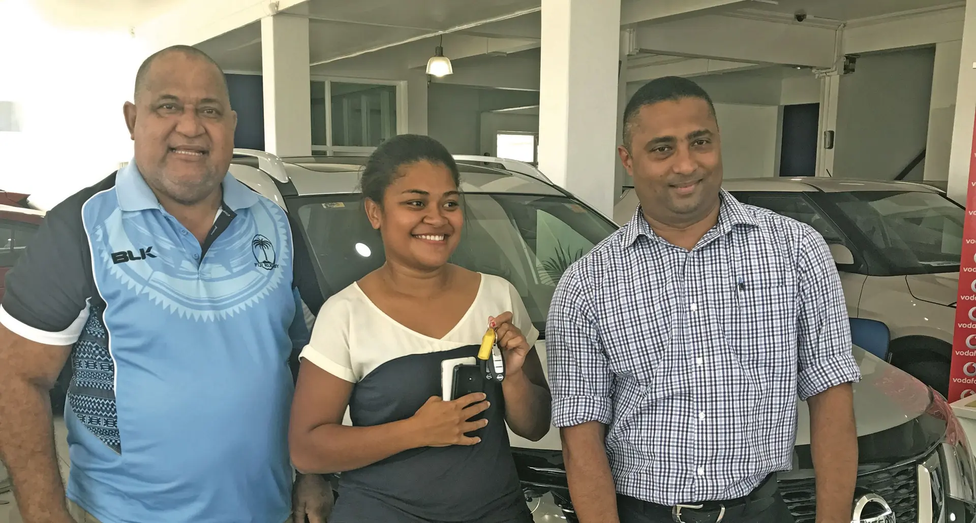 Jiale Lenoa (left) Vodafone Fiji Chief Operating Officer Ronald Prasad (right) standing in front of the 2017 Nissan Xtrail Mr Lenoa won from the MH TEXT AND WIN Promotion. Photo: Maraia Vula