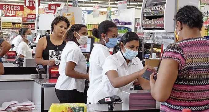 Staff of MH Superfresh on Mead Road in Tamavua serving customers with COVID-19 safety measures in mind.  Photo: Ronald Kumar