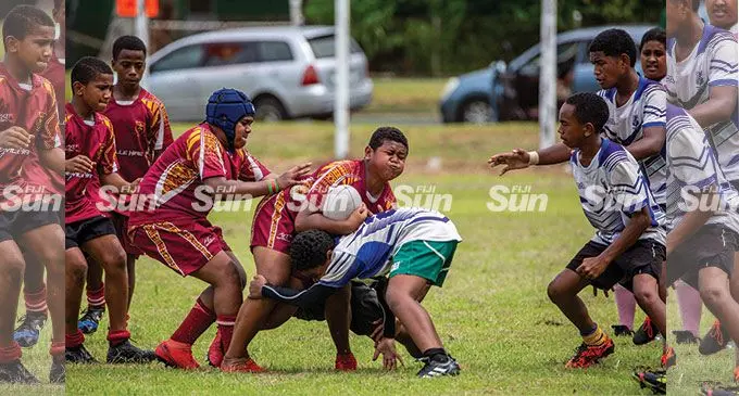 Nabua Juniors prop Senaila Vakaduruo (with ball) on attack against Suva Cavaliers Under-14 side during the Ram Sami Suva Kaji rugby competition at the Suva Grammar School ground on April 7, 2022. Photo: Leon Lord