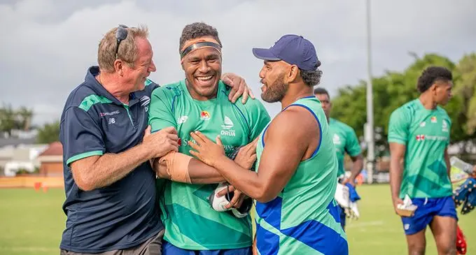 Labasa-born Swire Shipping Fijian Drua lock Leone Rotuisolia (middle) is congratulated by head coach Mick Byrne on his 24th birthday ar Lennox Head in New South Wales, Australia on February 21, 2022. Photo: Fijian Drua