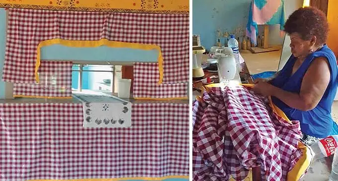 Asinate Kama at work with recycled pieces of material to create a final piece for her home.
