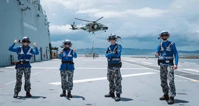 Members of the Australian Defence Force on the HMAS Adelaide in Vanua Levu. The ADF men and women are assisting the Republic of Fiji Military Forces (RFMF) to make a real difference to cyclone-affected communities – especially efforts to rebuild schools in time for the start of the school year. In doing so, the ADF men and women are following COVID-safe requirements at all times. Photo: Australian Defence Force