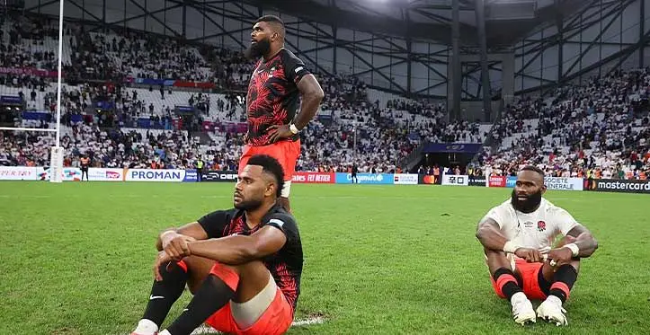 From left Vilimoni Botitu, Albert Tuisue (standing) and Semi Radradra after the last whistle of their quarter-final loss to England on October 16, 2023 in France.. Photo: FRU Media
