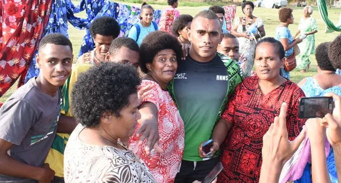 Fiji Airways Fijian 7s rep Eroni Sau flanked by villagers of Cautata on February 16, 2018.Photo: Ronald Kumar