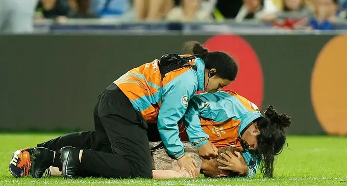 A male streaker is nabbed to the ground by women security officers during the quarterfinal clash between New Zealand and Wales at the Northland Events Centre in Auckland, New Zealand, on October 29, 2022. Photo: World Rugby