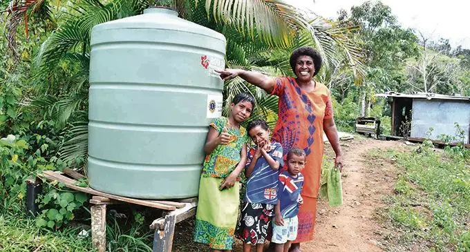 Atelaite Vakaloloma with the new water tank. Photo: Office of the Prime Minister