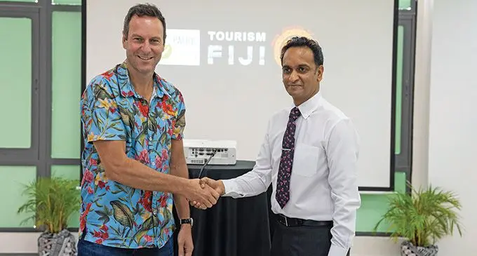 Tourism Fiji chief executive officer Brent Hill seals a partnership with Pacific Recycling Foundation chief executive officer, Amitesh Deo at the Sheraton Fiji Golf & Beach Resort.