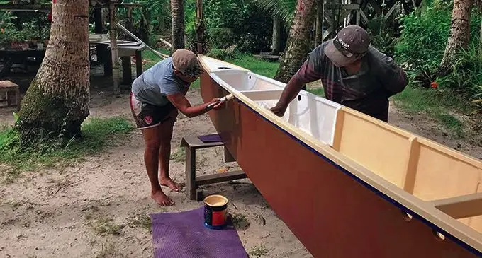 Members of the Uto ni Yalo Trust put the finishing coat on a traditional sailing boat. It is one of 100 they plan to give out to help rural communities.  Photo: Courtesy of Dwain Ah Tong