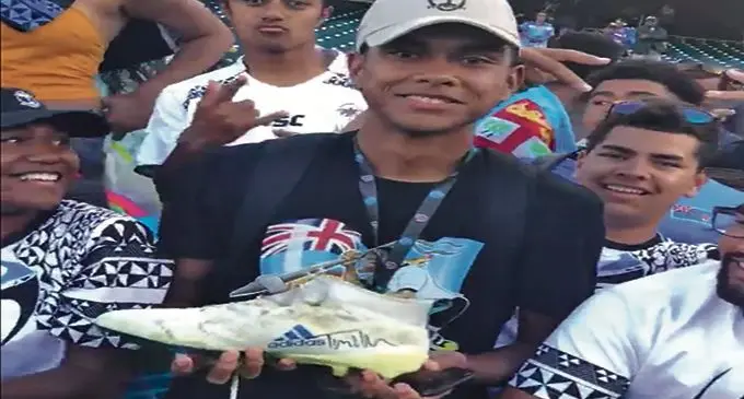 Treasured possession ... a Fijian rugby fan walked away with an autographed rugby boot from All Blacks 7s player Tim Mikkelson after the World Cup Sevens final in San Francisco. 