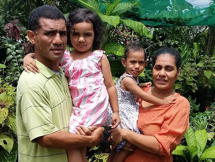 Mausio Susau (left) with his wife, Magirita Susau (right) and their children at their flower garden. Photo: Maika Bolatiki