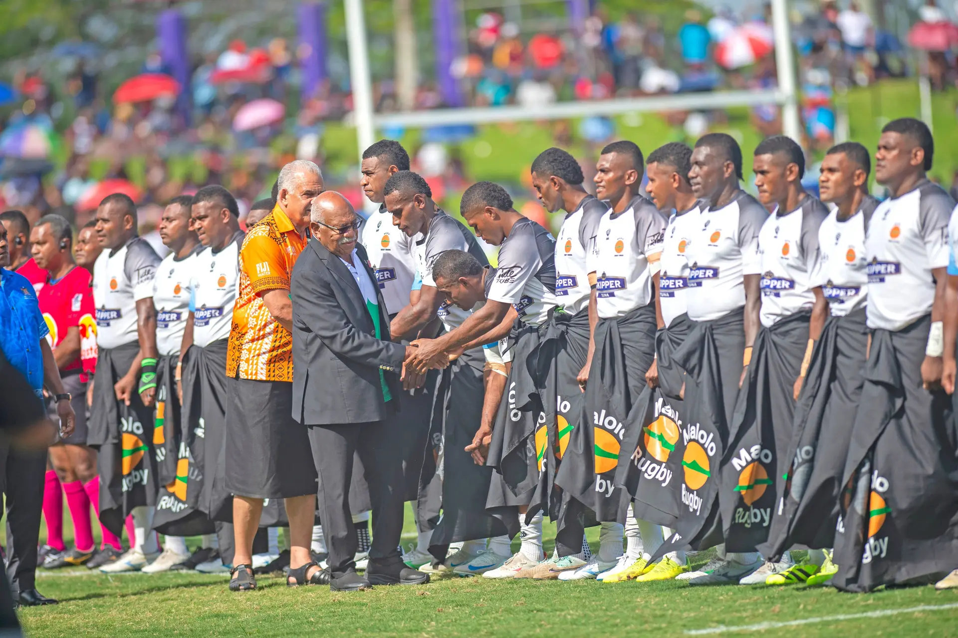 Prime Minister Sitiveni Rabuka meets members of the Malolo team prior to the Skipper Cup final match.