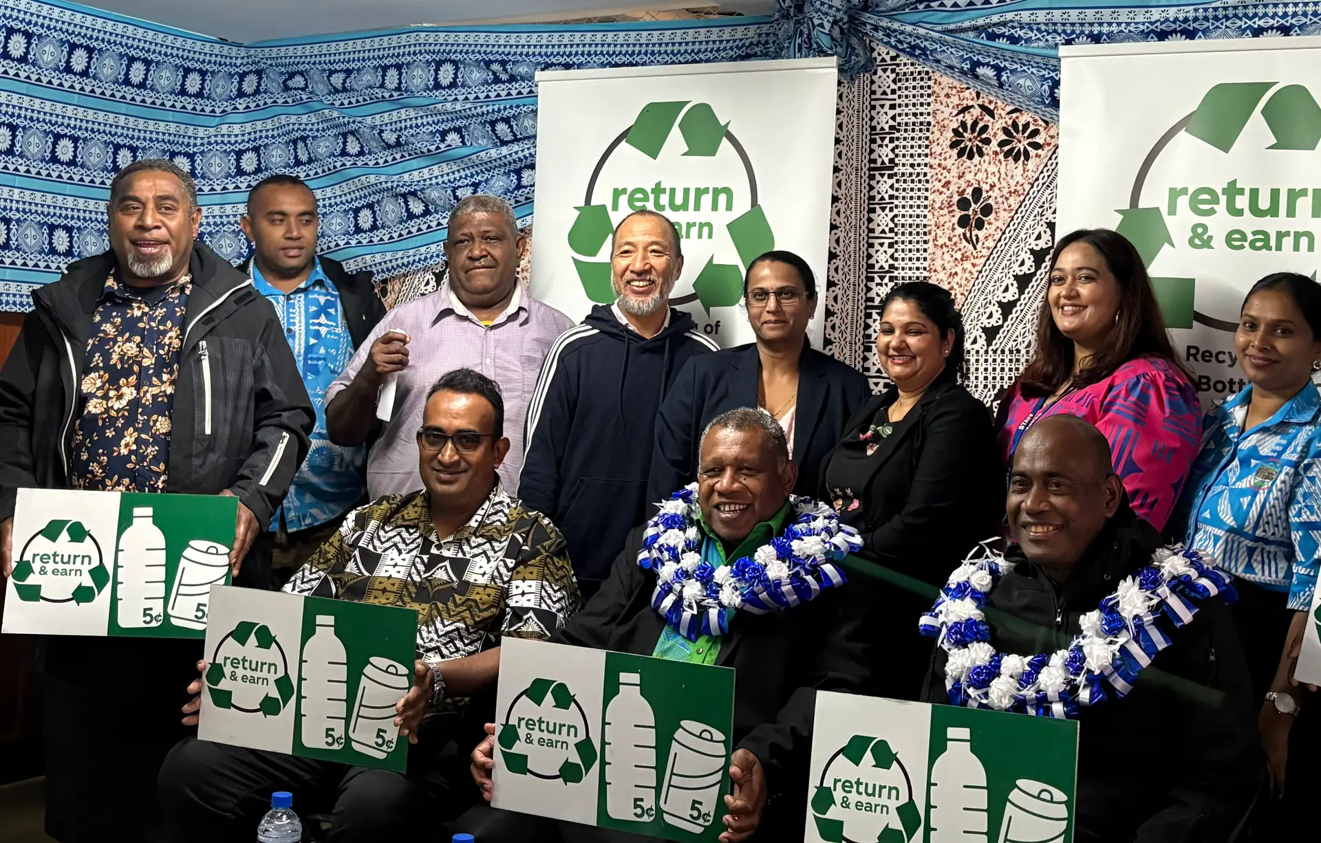 Front row, from left: Nausori Town Council Acting Chief Executive Officer Rajesh Kumar, Special Administrator Paula Navunisaravi and Korovou District Office representative Alipate Tagidugu join members of the Korovou Market and business community at the official opening of the Korovou Return & Earn Centre.