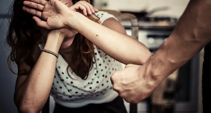 Woman Covering Her Face In Fear Of Domestic Violence