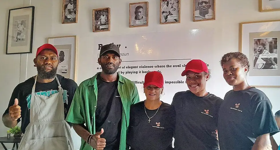 From left: Fijian Drua rep Peni Matawalu, his brother Pauliasi Matawalu and The Rugby Cafe workers Helen  Regan, Losena Naituyaga and Unaisi Tuidomo at the cafe surrounded by rugby memorabilia.