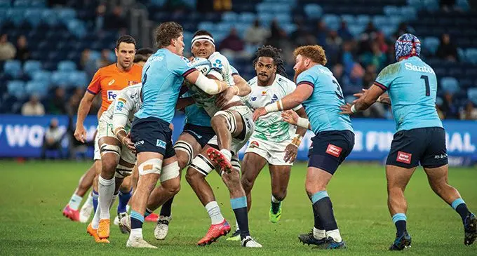 Waratahs blindside flanker Will Harris holds up Swire Shipping Fijian Drua flanker Vilive Miramira while Selestina Ravutaumada comes in to support at the Allianz Stadium, Sydney, on May 20, 2023. Photo: Leon Lord 