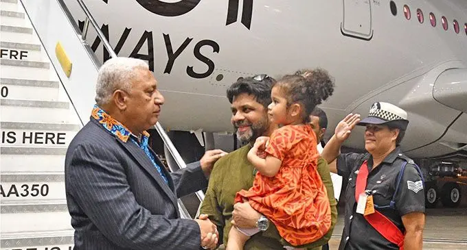 Prime Minister Voreqe Bainimarama, is welcomed by Attorney-General, Minister for Economy and Minister responsible for Civil Aviation, Aiyaz Sayed-Khaiyum and his daughter, Imaan Sayed-Khaiyum in front of the second Fiji Airways A350-900 XWB ‘Island of Vanua Levu’ on December 16, 2019.