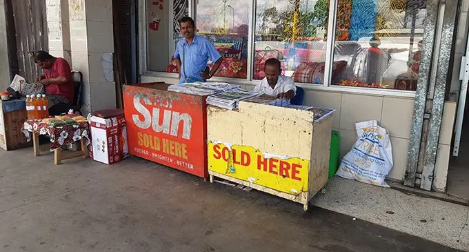 Mohan Prasad (right) at his newspaper stand at Rodwell Road in Suva.  Photo: Shalveen Chand