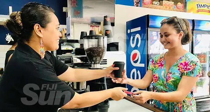 Weta Coffee barista Kat Hiagi serves Dawn Gibson of the Australian High Commission a cup of coffee on January 6, 2020. Photo Frederica Elbourne