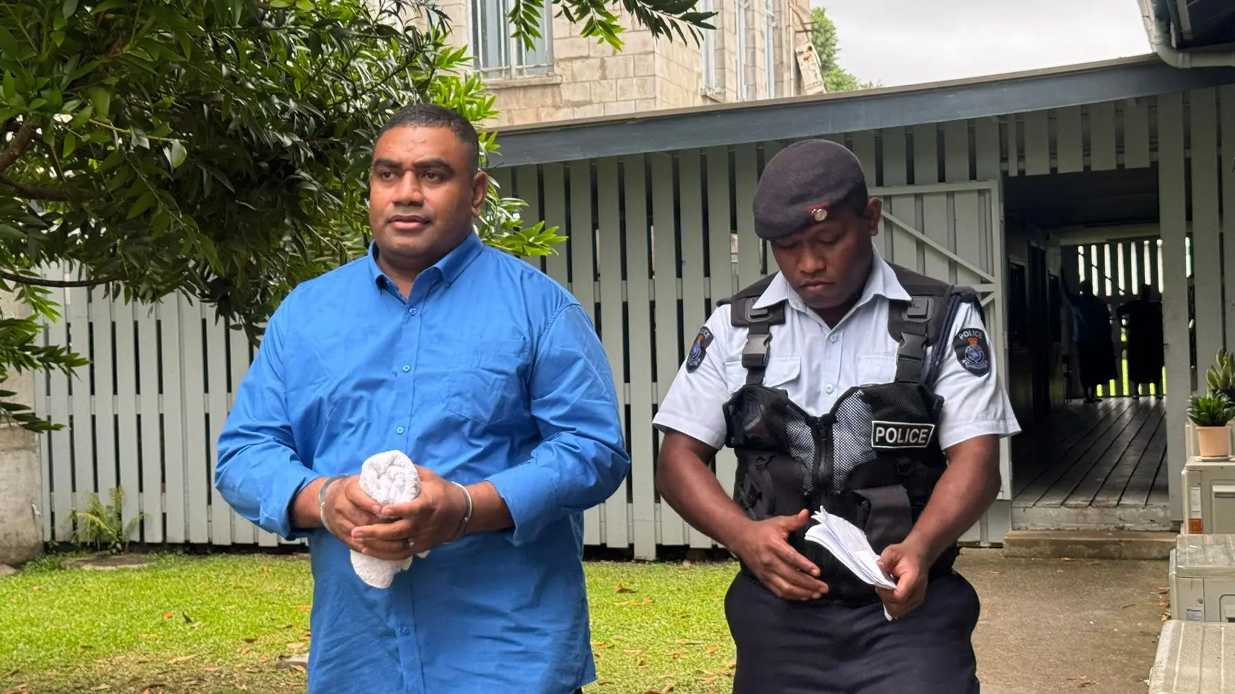 Drug accused, Eroni Bati with Police escorting officer outside the Suva Magistrate Court on November 4, 2025.