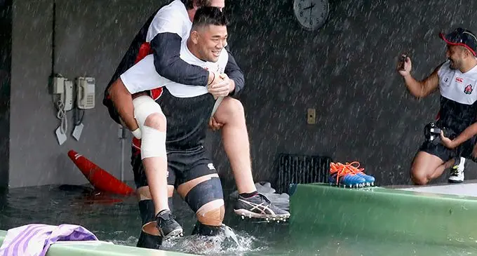 Japan rugby players in flood waters brought by Typhoon Hagibis before their final pool game against Scotland last night in the Rugby World Cup. The Rugby World Cup continued last night (Fiji Time) after the Namibia-Canada and New Zealand-Italy games were cancelled because of the typhoon. Each team got two points.   Photo: Japan Rugby Football Union/Reuters