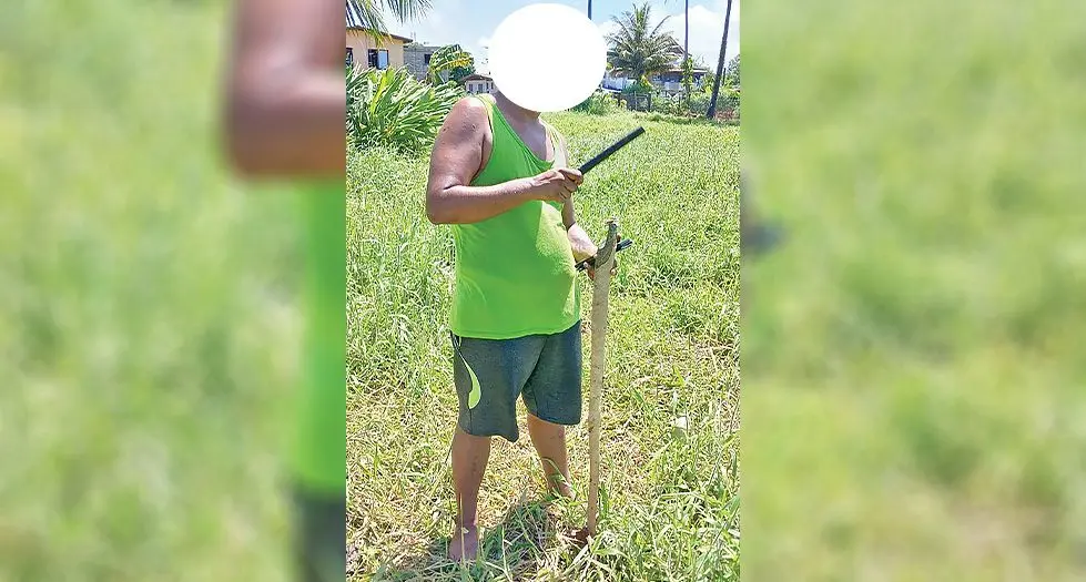 A service technician illegally surveying a property in Suva. 